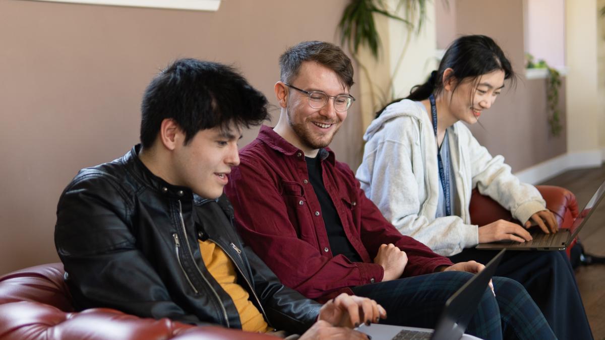 Three students with laptops