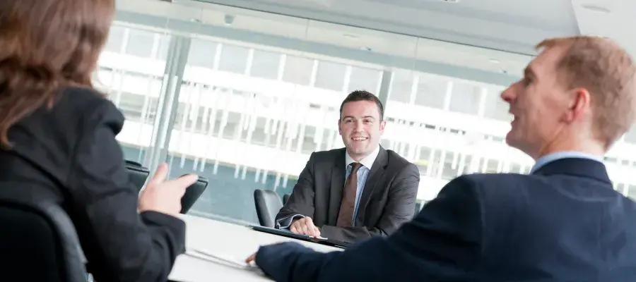 Three people in business attire conducting a interview