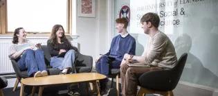 students sitting down and conversing