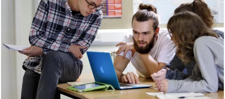 students looking at a laptop