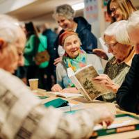 senior people reading gaelic books