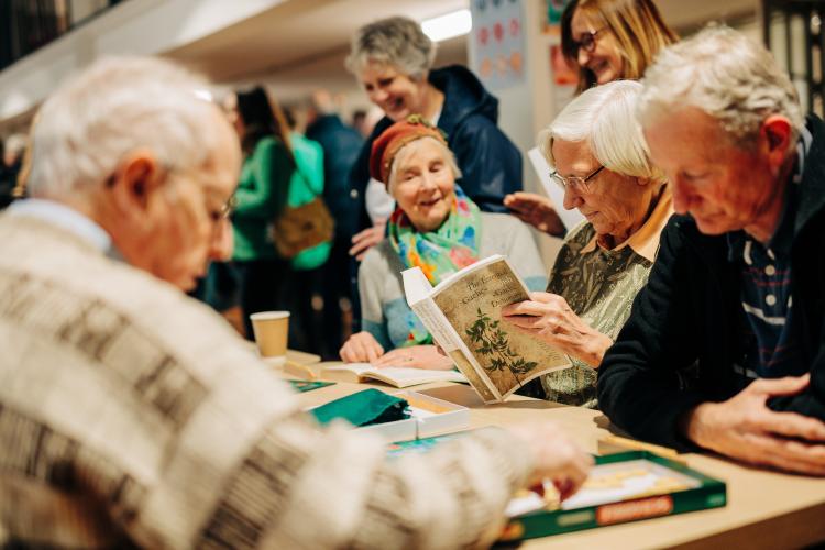 senior people reading gaelic books