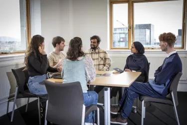 A group of people sit around a table